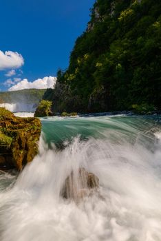 single stone in wild river landscape  long exposure photo representing liquid flow concept