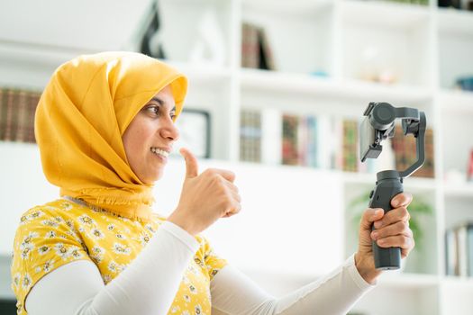 Muslim woman streaming video content online at home