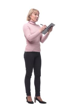 Full length portrait of smiling business woman pointing on blank clipboard isolated over white background