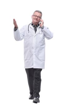 Middle age handsome grey-haired doctor man talking smartphone isolated white background. Concept of positive emotion