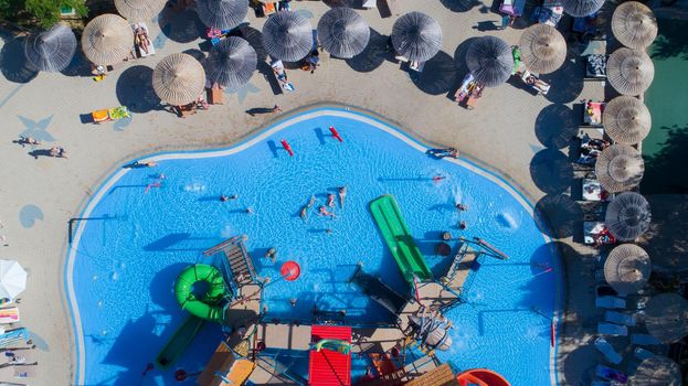 colorful water park aquapark water splash aerial top view of happy unidentified people and kids having fun and get relaxed