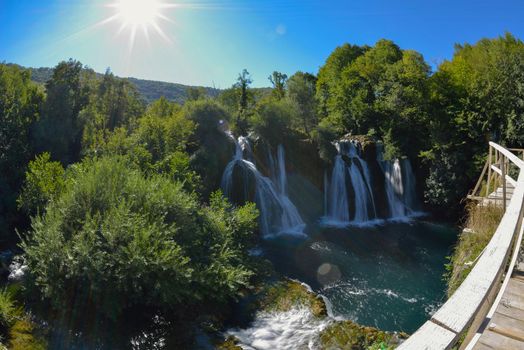 waterfall on wild river with fresh drinking water in summer