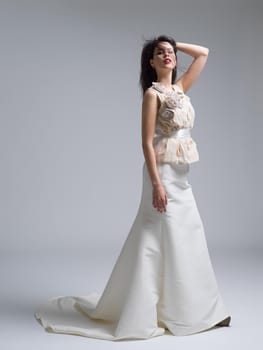 Portrait of beautiful young women in wedding dress isolated on a white background