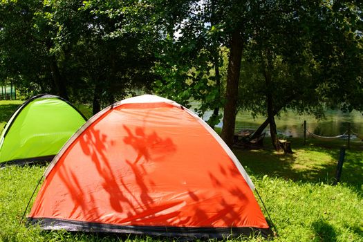 calm relaxing camp tent near the beautiful river on sunny summer day