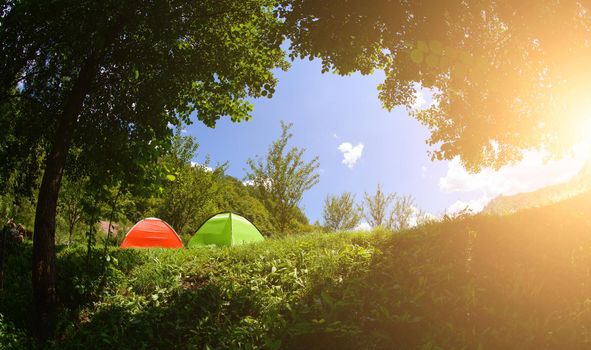 calm relaxing camp tent near the beautiful river on sunny summer day