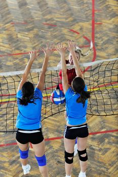 volleyball game sport with group of young beautiful  girls indoor in sport arena