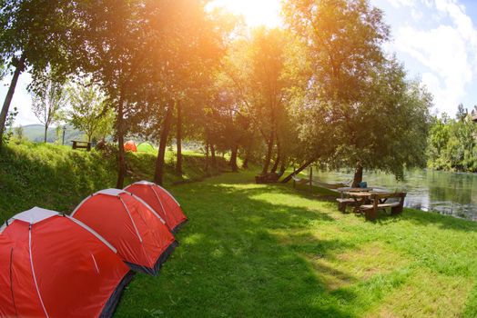 calm relaxing camp tent near the beautiful river on sunny summer day