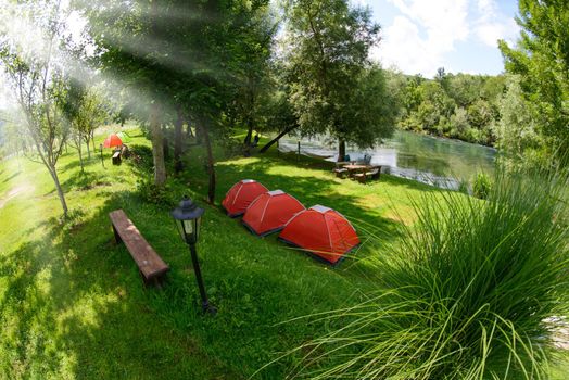 calm relaxing camp tent near the beautiful river on sunny summer day