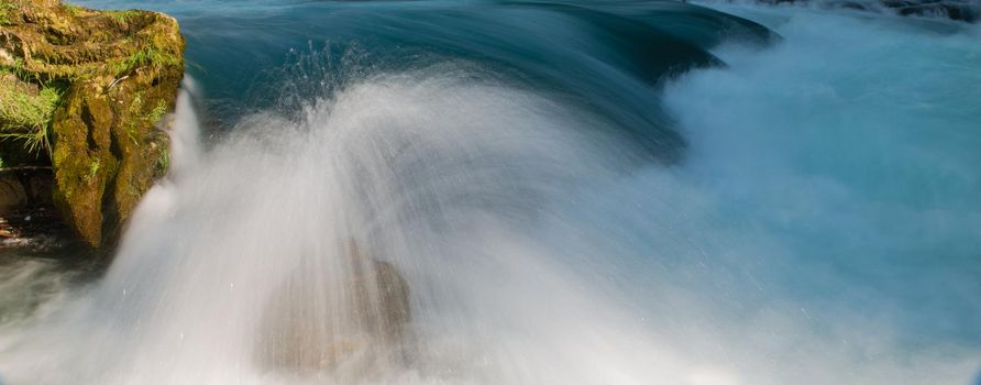 single stone in wild river landscape  long exposure photo representing liquid flow concept