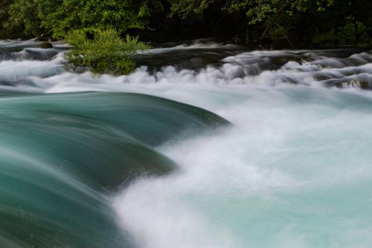 waterfall in beautiful nature with crystal clear water on wild river una in bosnia and herzegovina at sunny summer day