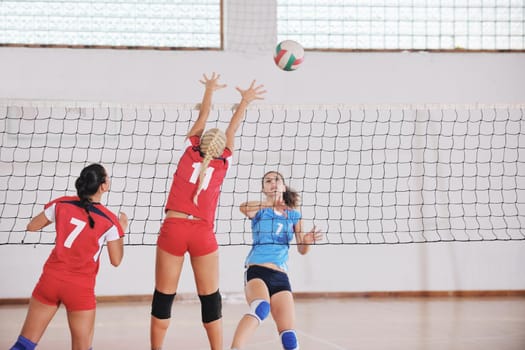 volleyball game sport with group of young beautiful  girls indoor in sport arena