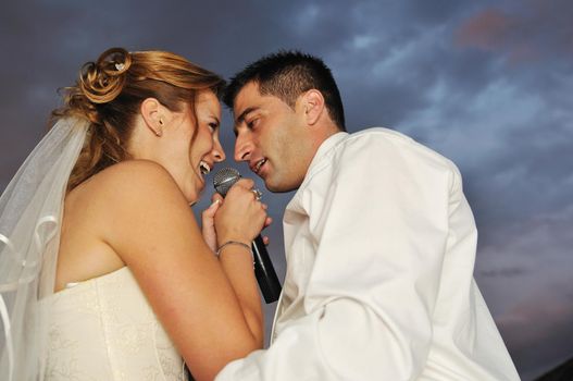 happy young and beautiful bride and groom at wedding party  outdoor