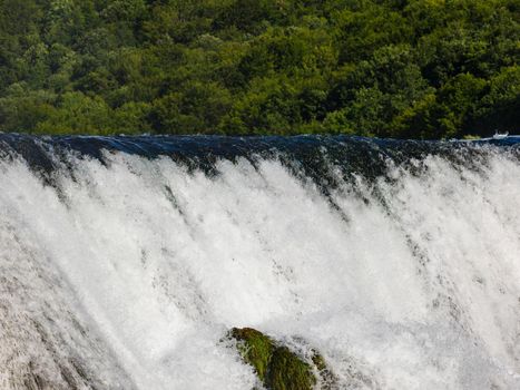 waterfall in beautiful nature with crystal clear water on wild river una in bosnia and herzegovina at sunny summer day