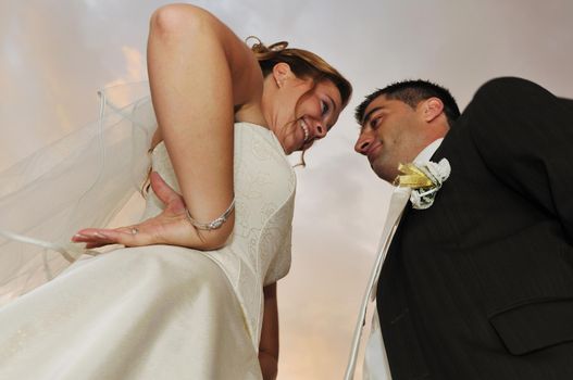 happy young and beautiful bride and groom at wedding party  outdoor