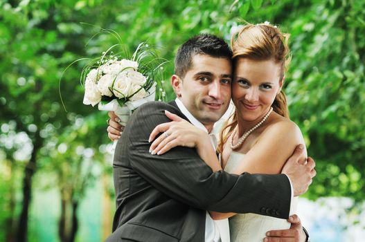 happy young and beautiful bride and groom at wedding party  outdoor