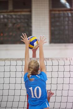 volleyball game sport with group of young beautiful girls indoor in sport arena school gym