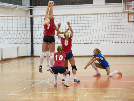 volleyball game sport with group of young beautiful girls indoor in sport arena school gym