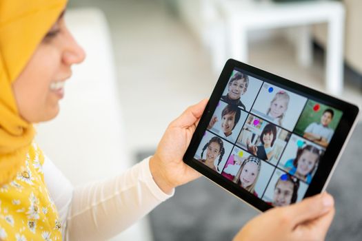 Arabic female teacher working with children online school during pandemic