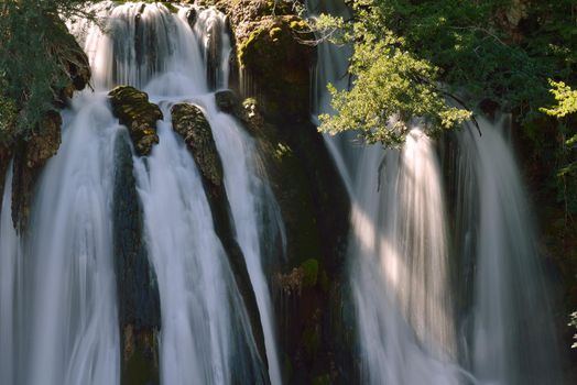 waterfall on wild river with fresh drinking water in summer