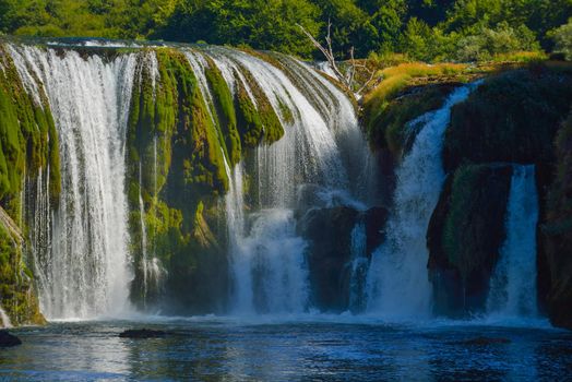 waterfall on wild river with fresh drinking water in summer