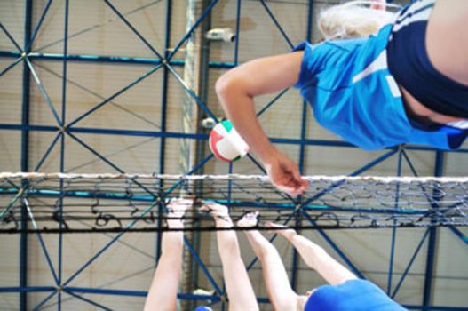 volleyball game sport with group of girls indoor in sport arena