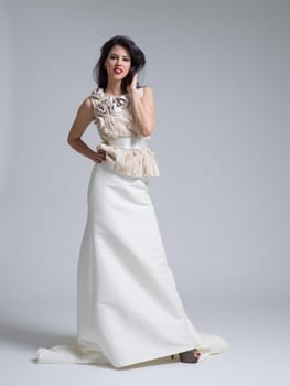 Portrait of beautiful young women in wedding dress isolated on a white background