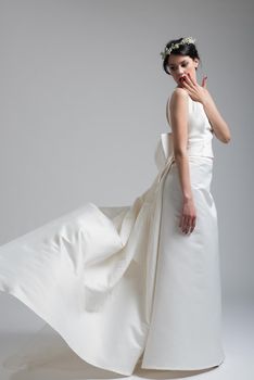 Portrait of beautiful young women in wedding dress isolated on a white background