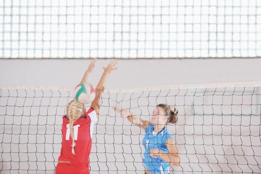 volleyball game sport with group of young beautiful  girls indoor in sport arena