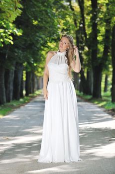 beautiful bride woman people in fashion wedding dress posing outdoor in bright park