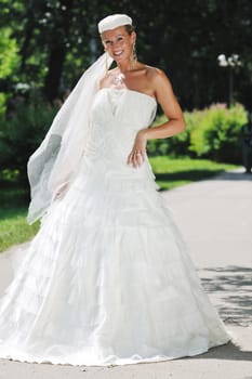 beautiful bride woman people in fashion wedding dress posing outdoor in bright park