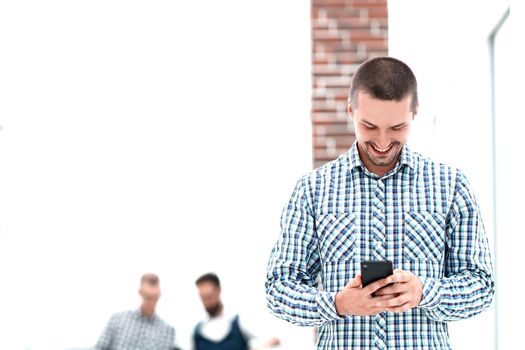 young man reading a SMS on his smartphone.people and technology