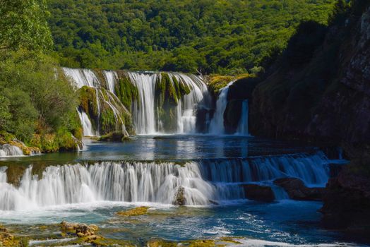 waterfall on wild river with fresh drinking water in summer