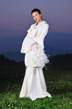 happy young beautiful bride after wedding ceremony event have fun on meadow in fashionable wedding dress