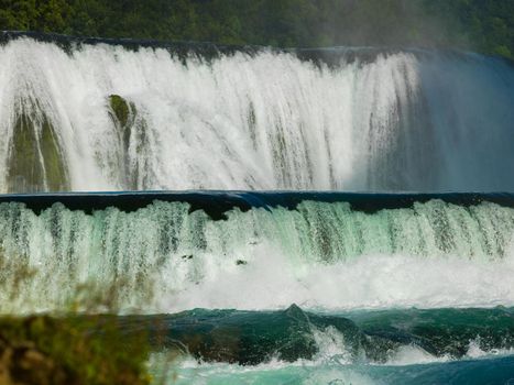 waterfall in beautiful nature with crystal clear water on wild river una in bosnia and herzegovina at sunny summer day