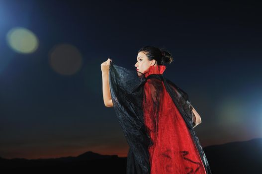 young beautiful bride in black wedding dress in dar at night 