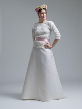 Portrait of beautiful young women in wedding dress isolated on a white background