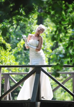 beautiful bride woman people in fashion wedding dress posing outdoor in bright park