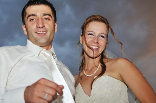 happy young and beautiful bride and groom at wedding party  outdoor