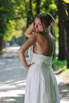 beautiful bride woman people in fashion wedding dress posing outdoor in bright park