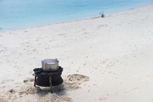 Having joy on beach sand making the food