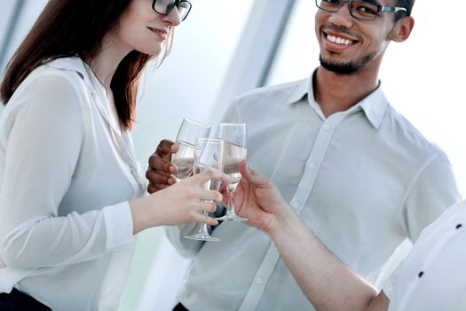 close up. glasses of wine in the hands of the business team. the concept of a successful startup