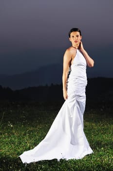 happy young beautiful bride after wedding ceremony event have fun on meadow in fashionable wedding dress