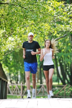 happy young younpe jogging and runing outdoor in nature at sunny day