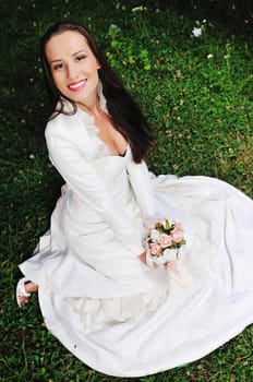 happy young beautiful bride after wedding ceremony event have fun on meadow in fashionable wedding dress