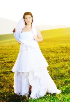 happy young beautiful bride after wedding ceremony event have fun on meadow in fashionable wedding dress