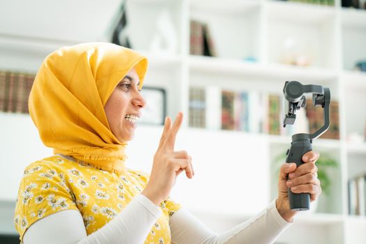 Muslim woman streaming video content online at home