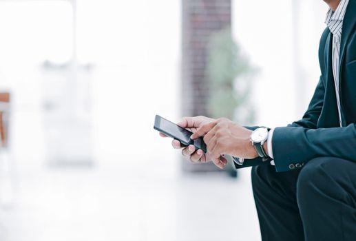 closeup. employee typing SMS on the smartphone.photo with copy space