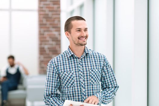 modern man standing near the office window .photo with copy space