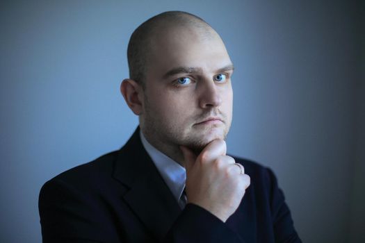 close up. thoughtful businessman looking at copy space.isolated on grey background