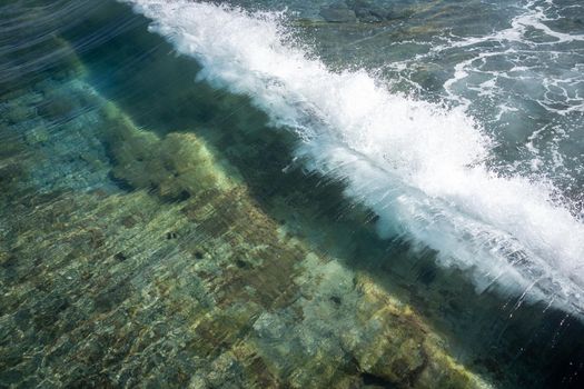 Sea water makin beautiful waves under sun